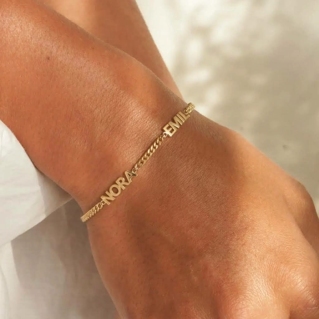 Personalised gold-tone name bracelet close-up
